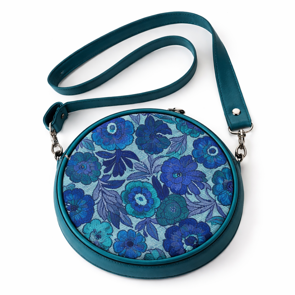 Round floral-patterned bag with a blue and green color scheme on a white background#color_lagoon-bloom