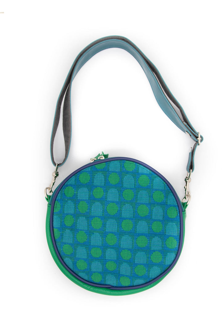 Round blue and green patterned bag with a strap on a white background#color_arcade-dots-blue-green