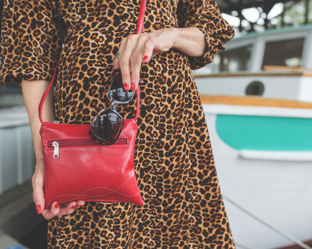 woman in leopard print dress wearing Cha Cha Small Crossbody Bag - Cherry Red Vegan Leather